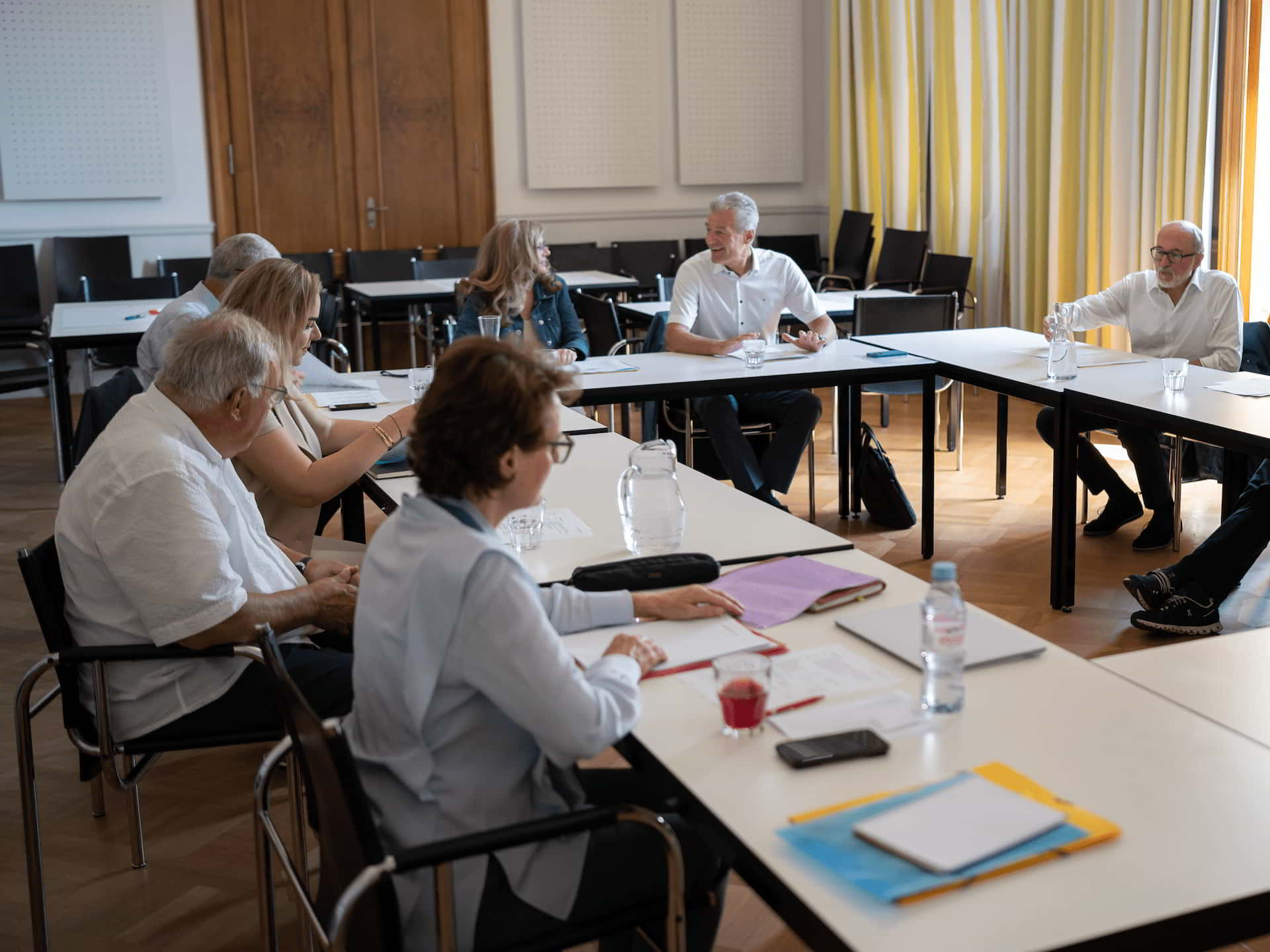 Board members at a meeting of the Board of Trustees