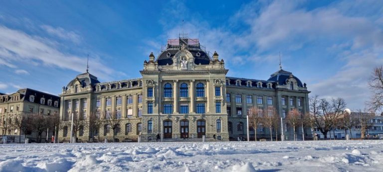 Main building of the University of Bern covered in snow in winter