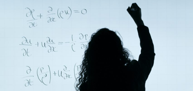 Silhouette of a woman in front of a whiteboard with mathematical equations